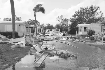  ??  ?? Property damage is seen at a mobile home park after passing of Hurricane Irma in Naples, Florida. — Reuters photo