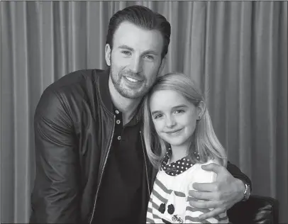  ?? The Associated Press ?? ‘GIFTED’ ACTORS: In this March 23, 2017 photo, Chris Evans, left, and McKenna Grace, cast members in the film “Gifted,” pose for a portrait at the Four Seasons Hotel in Los Angeles. Evans stars as a single guy raising his math-prodigy niece, played by...