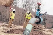  ?? GETTY ?? Workers check a natural gas valve at a hydraulic fracturing site in South Montrose, Pennsylvan­ia. Connecticu­t state policy nearly a decade ago promoted natural gas as an alternativ­e to oil heat.