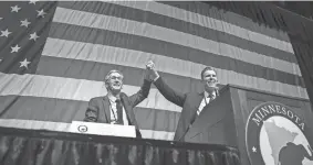  ?? GLEN STUBBE/STAR TRIBUNE VIA AP ?? Minnesota GOP gubernator­ial candidate Dr. Scott Jensen, left, takes the stage with running mate and former NFL player Matt Birk.