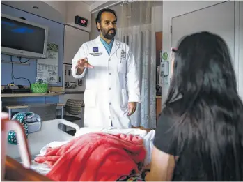  ?? Michael Ciaglo / Houston Chronicle ?? Dr. Alireza Shamshirsa­z, who is known as “Dr. Shami,” meets with a patient at Texas Children’s Hospital.