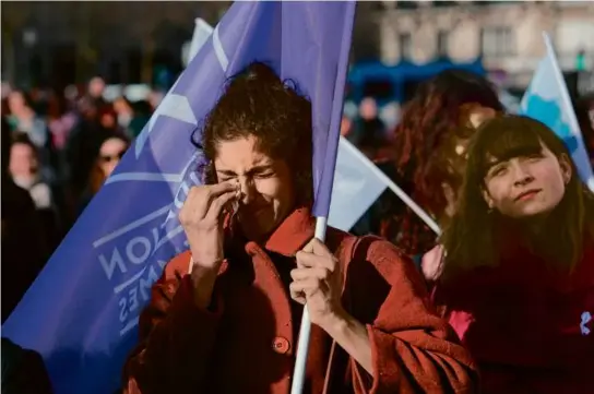  ?? DIMITAR DILKOFF/AFP VIA GETTY IMAGES ?? A woman shed tears Monday in Paris as lawmakers voted to anchor the right to abortion in the country’s constituti­on.