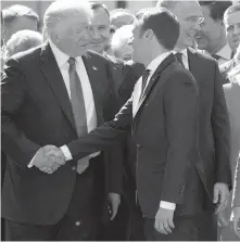  ??  ?? U.S. President Donald Trump shakes hands with French President Emmanuel Macron in Brussels on Thursday as they meet for the first time.