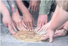  ?? CHONMAHATR­AKOOL ARNUN ?? The so-called 2nd Khana Ratsadon Plaque is fitted into a concrete surface in the grounds of Sanam Luang yesterday morning after a brief ceremony held by protesters to round off the Sept 19 student-led rally over the weekend.