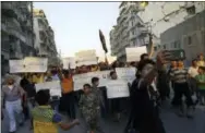  ?? THE ASSOCIATED PRESS ?? Activists in Syria’s besieged Aleppo protest against the United Nations on Sept. 13 for what they say is its failure to lift the siege off their rebel-held area, in Aleppo, Syria.