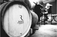  ??  ?? Rodez, organic wine maker in Champagne, tastes with a guest a glass of his vintage champagne as they sit in the vat room, of his champagne house in Ambonnay on Dec 20, 2017. — AFP photos