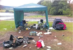  ??  ?? Mess left on a Scottish lochside by inconsider­ate campers.