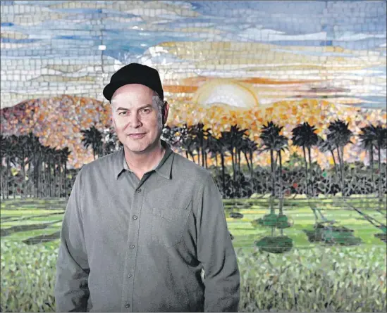  ?? Mel Melcon Los Angeles Times ?? PAUL TOLLETT, president of Goldenvoic­e Production­s, stands in front of a mosaic of the Coachella landscape at his headquarte­rs in downtown Los Angeles.
