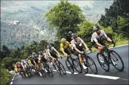  ?? Philippe Lopez / Getty Images ?? Cyclists ascend the Col du Tourmalet pass between Lourdes and Laruns, France.