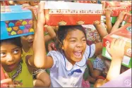  ?? Operation Christmas Child / Contribute­d photo ?? Above, children receive their boxes of gifts from Operation Christmas Child.