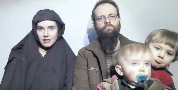  ?? THE CANADIAN PRESS / TALIBAN MEDIA VIA THE ASSOCIATED PRESS FILES ?? Caitlan Coleman talks while her Canadian husband Joshua Boyle holds their two children. The American wife of Boyle has reportedly returned to the U.S. with the couple’s three children while Boyle awaits trial on assault charges.