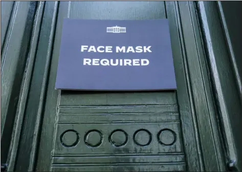  ?? JOSHUA ROBERTS — GETTY IMAGES ?? A sign requiring the wearing of face masks is displayed at the testing center for visitors to the White House on July 30 in Washington.