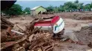  ??  ?? A damaged truck is seen in an area affected by landslides and flash floods in East Flores, Indonesia