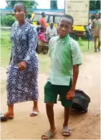  ??  ?? A student leaves the school premises with his mother