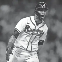  ?? ASHLEY LANDIS/AP ?? The Braves’ Eddie Rosario celebrates after hitting a game winning RBI single during the ninth inning against the Dodgers on Sunday in Atlanta.