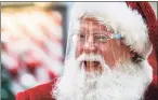  ??  ?? A man dressed as Santa Claus wears a protective face shield at Capital City Mall in Lower Allen Township, Pa., on Wednesday.