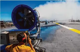  ?? Yalonda M. James/The Chronicle ?? Matthew Gallelli with SRI Internatio­nal conducts research aboard the aircraft carrier Hornet in Alameda on April 2. The city of Alameda has halted the work.