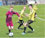  ??  ?? An Arbroath U/14 player (maroon) looks to break in the 2-0 Jim Duffy Cup Final loss to Pitfour.