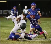  ?? EDDIE SALTZMAN — ENTERPRISE-RECORD ?? Durham’s Avery Merlo (5) and Aaron Hernandez (44) take down Paradise tight end Kyle Ricker in the first half in Durham on Friday night.