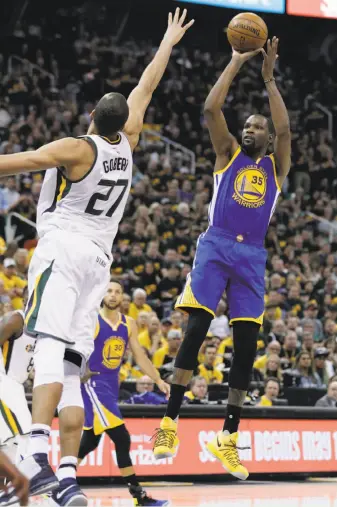  ?? Carlos Avila Gonzalez / The Chronicle ?? Forward Kevin Durant, who scored 38 points, puts up a shot over Jazz center Rudy Gobert in the second half of the Warriors’ Game 3 victory at Vivint Smart Home Arena in Salt Lake City.