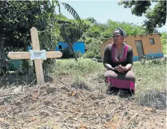  ?? Picture: Jackie Clausen ?? Zandile Lembethe at the grave of her brother Jabulani Lembethe. A farmer has been accused of killing a mourner at Lembethe’s funeral last week.