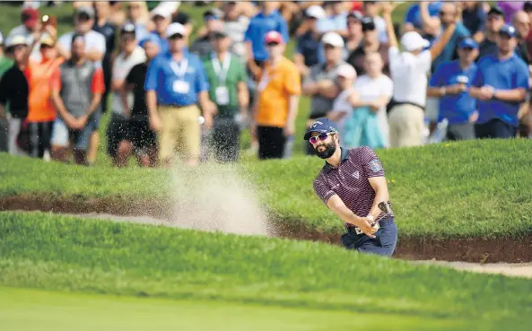  ?? GETTY IMAGES ?? Adam Hadwin plays a shot from a bunker on the 18th hole en route to a 2-under 70 during Thursday’s opening round of the Canadian Open at Glen Abbey in Oakville, Ont.