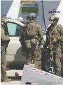  ?? TIM KROCHAK/AFP VIA GETTY IMAGES ?? RCMP tactical members confer after Nova Scotia gunman Gabriel Wortman
was killed on April 19.