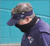  ?? Mark Brown / Getty Images ?? Patriots coach Bill Belichick walks off the field after Sunday’s loss to the Dolphins. The Dolphins eliminated the Patriots from playoff contention with the 22-12 win.