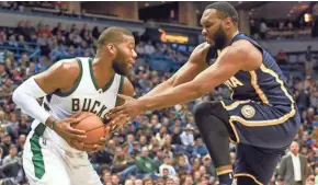  ?? BENNY SIEU / USA TODAY SPORTS ?? Bucks center Greg Monroe takes the ball away from the Pacers’ Al Jefferson in the second quarter on Friday. Monroe scored 18 points off the bench.