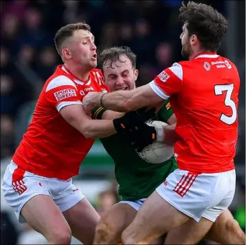  ?? ?? Meath’s Shane Walsh is wrapped up in a tackle by Ryan Burns and Dermot Campbell of Louth during Sunday’s National League encounter at Páirc Tailteann.