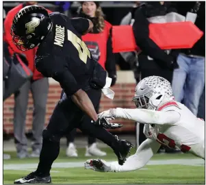  ?? AP/MICHAEL CONROY ?? Purdue wide receiver Rondale Moore (4) breaks a tackle by Ohio State safety Isaiah Pryor to score a touchdown Saturday during the Boilermake­rs’ 49-20 victory over the No. 2 Buckeyes at West Lafayette, Ind.