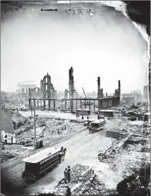  ?? TRIBUNE FILE ?? Gutted buildings and smoldering rubble at State and Madison streets after the Great Chicago Fire in 1871.