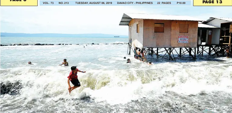  ??  ?? CHILDREN are having fun with the big waves that hit the coastal area of Isla Verde, Barangay 23-C, Poblacion District where several houses were destroyed on Saturday. BING GONZALES