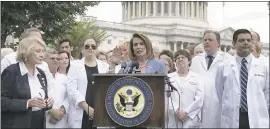  ??  ?? House Democratic Leader Nancy Pelosi, center, speaks alongside doctors, nurses and healthcare providers against the Republican healthcare bills on Capitol Hill on Thursday.