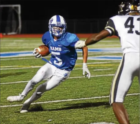  ?? GREGG SLABODA — TRENTONIAN PHOTO ?? Hightstown’s Michael Quigg (5) picks up yardage against Burlington Twp. on Thursday night.