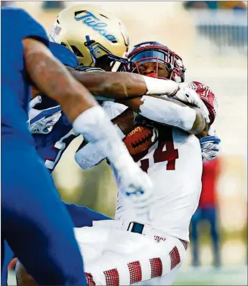  ?? WARDARSKI/TULSA WORLD VIA AP] ?? In this Nov. 25, 2017, file photo, Temple’s David Hood, right, is tackled by the Tulsa defense during a game in Tulsa, Okla. Hood took the field one more time. The running back-turned-rapper performed at halftime on Thur sdayn ight at Lincoln Financial Field the new Temple sports anthem he wrote, called “Temple Made.” [JESSIE