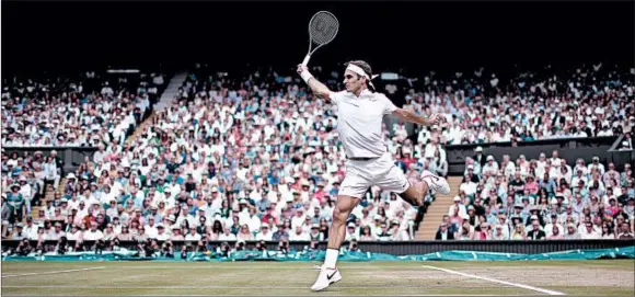  ?? TIM CLAYTON/GETTY ?? Roger Federer in action on Wimbledon’s Centre Court against Marin Cilic during the men’s singles final last year. Federer became the first man to win Wimbledon eight times.