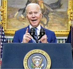  ?? EVAN VUCCI/AP ?? President Joe Biden on Wednesday highlighte­d new figures showing the government’s debt will shrink this quarter.
