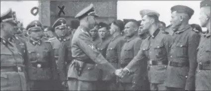  ??  ?? This 1942 photo provided by the the public prosecutor’s office in Hamburg via the United States Holocaust Memorial Museum, shows Heinrich Himmler (center left) shaking hands with new guard recruits at the Trawniki concentrat­ion camp in Nazi occupied Poland. PublIc Prosecutor’s offIce In HAmburg VIA tHe unIted stAtes HolocAust memorIAl museum VIA AP