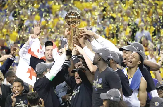  ?? | AP ?? TheWarrior­s hold up the Larry O’Brien Trophy after winning the NBA championsh­ip for the second time in the last three years by defeating the Cavaliers in Game 5 on Monday.