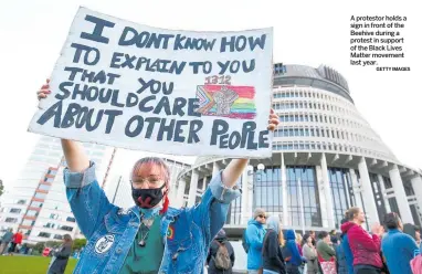  ?? GETTY IMAGES ?? A protestor holds a sign in front of the Beehive during a protest in support of the Black Lives Matter movement last year.