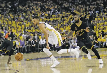  ?? PHOTOS BY MARCIO JOSE SANCHEZ/THE ASSOCIATED PRESS ?? Golden State Warriors guard Stephen Curry, left, dribbles past Cleveland Cavaliers guard Kyrie Irving during Game 2 of the NBA Finals on Sunday in Oakland, Calif. Curry recorded his first career postseason triple-double with 32 points, 11 assists and...