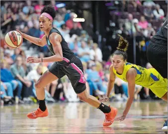  ?? SARAH GORDON/THE DAY ?? Jasmine Thomas of the Connecticu­t Sun, left, steals the ball from Brooke McCarty-Williams of the Dallas Wings during Sunday’s WNBA game at Mohegan Sun Arena.