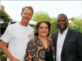  ??  ?? Walter Buckley of Wayne gets a heartfelt “thank you” for hosting the annual fundraiser from AEP board members Marie Odile-Cosenza of Wayne and Bradford Machila of Lusaka Zambia.