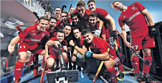  ??  ?? Selfie sticks: England players take a photograph of themselves as they celebrate their battling 3-2 victory over Olympic champions Argentina in the World Cup