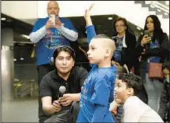  ?? ?? During Autism Awareness month in April, the MTA is tapping the talents of autistic kids who tend to be obsessed with trains. Above, Morgan Calles, 6, asks MTA officials when more new cars will come to the A line.