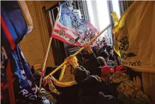  ?? Win Mcnamee/getty Images ?? Protesters on Jan. 6, 2021, wield flags and poles as weapons in defense of Donald Trump much as Captain Ahab’s crew was drawn into his quest for revenge against Moby Dick.