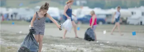  ?? MICHAEL BELL ?? Megan Secuur, left, empties a can while her mom Janine Secuur and sister Mia, right, also collect bottles and cans at the Craven Country Jamboree on Sunday. An organizer says public scrutiny of the jamboree largely ignores its family-friendly aspect in...