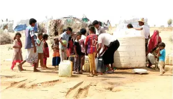  ?? — AFP file photo ?? Displaced Yemenis from Hodeida are seen filling their water barrels at a make-shift camp in a village in the northern district of Abs in Hajjah province.