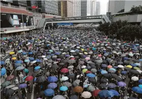  ?? Kin Cheung / Associated Press ?? Protesters surround government headquarte­rs in Hong Kong on Wednesday, condemning an extraditio­n bill that would send people to China for trial.